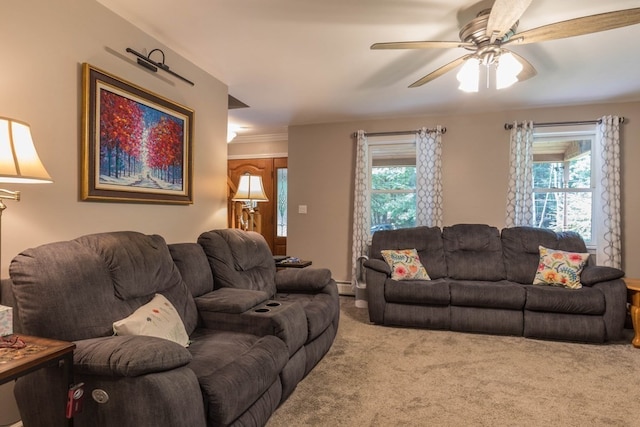 living room with ceiling fan, carpet floors, plenty of natural light, and crown molding