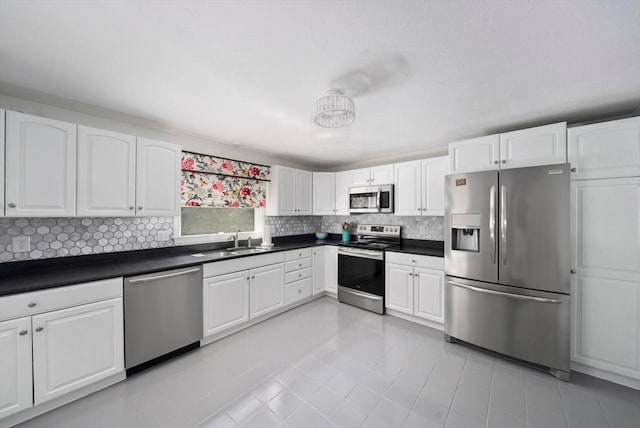 47 Pheasant Hill Rd, Weymouth, MA 02190 - kitchen featuring appliances with stainless steel finishes, backsplash, dark countertops, and light tile patterned floors