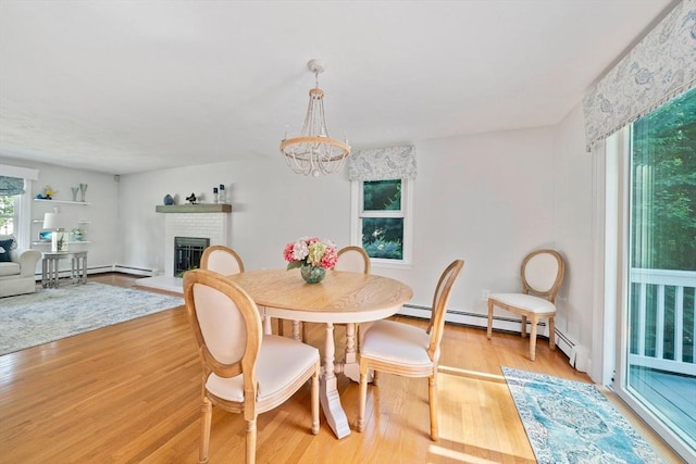 47 Pheasant Hill Rd, Weymouth, MA 02190 - dining space with a fireplace, light wood-type flooring, a chandelier, and a baseboard radiator