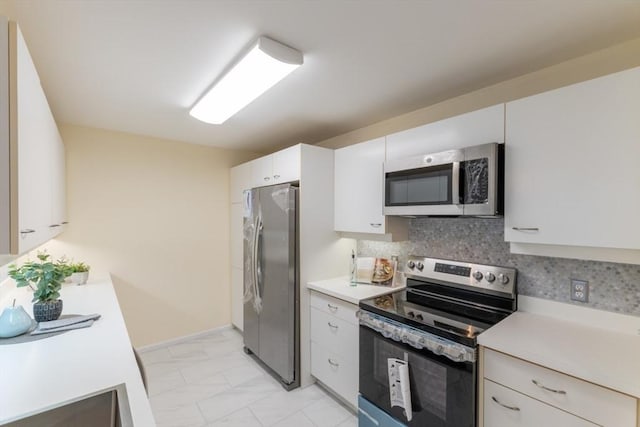 kitchen featuring white cabinetry, decorative backsplash, and appliances with stainless steel finishes