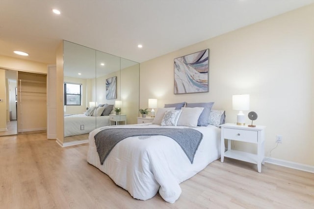 bedroom featuring light wood-type flooring and a closet