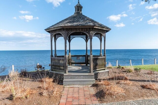 view of dock featuring a gazebo and a water view