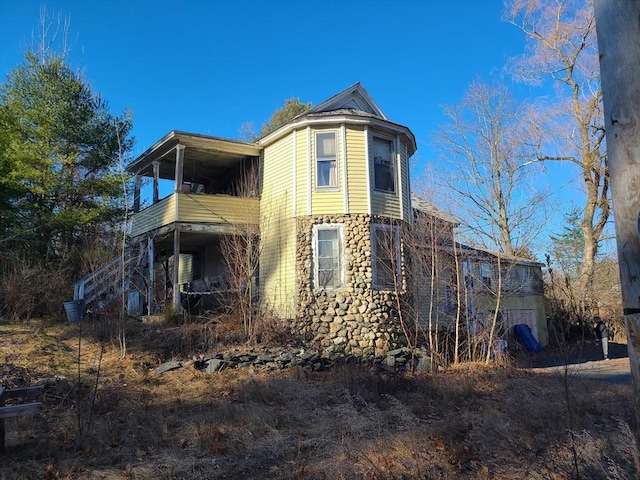 view of home's exterior with a balcony