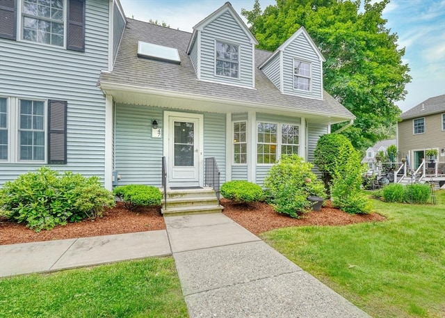 47 Key St Unit 47, Millis, MA 02054 - cape cod house featuring a front lawn, covered porch, and roof with shingles