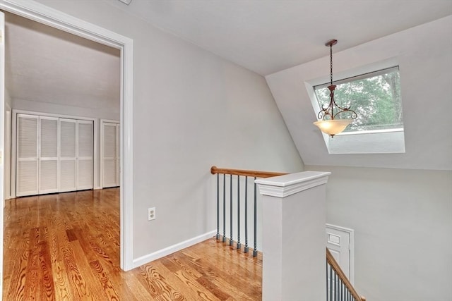 47 Key St Unit 47, Millis, MA 02054 - corridor featuring an upstairs landing, wood finished floors, and lofted ceiling