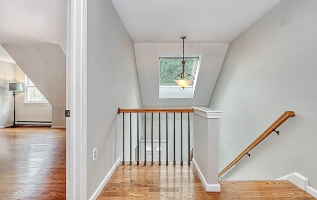 47 Key St Unit 47, Millis, MA 02054 - stairs with baseboard heating, wood finished floors, and vaulted ceiling