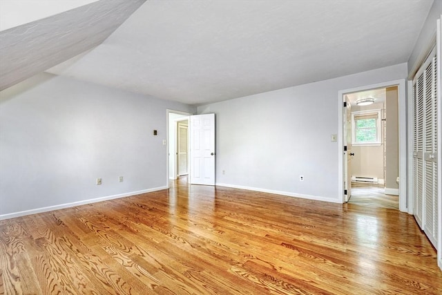 47 Key St Unit 47, Millis, MA 02054 - empty room with light wood-type flooring and a baseboard heating unit