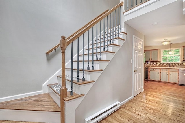 47 Key St Unit 47, Millis, MA 02054 - stairway featuring a baseboard radiator and wood finished floors