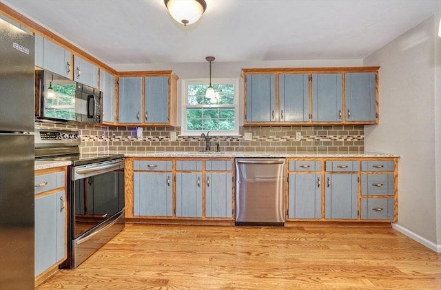 47 Key St Unit 47, Millis, MA 02054 - kitchen featuring stainless steel appliances, light wood-style floors, backsplash, and light countertops