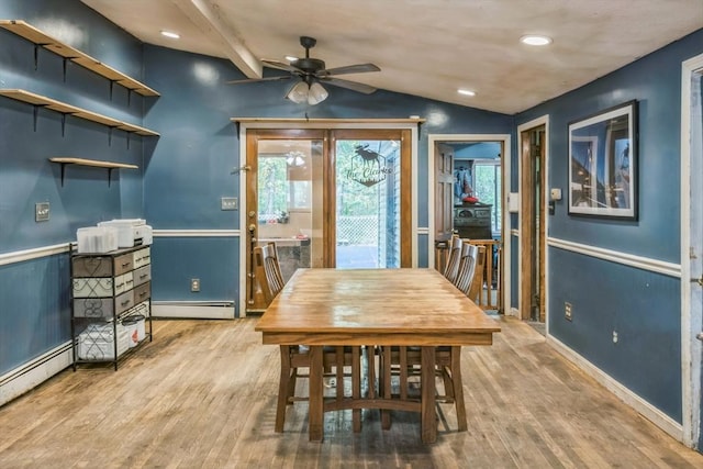 dining space featuring a wainscoted wall, a baseboard radiator, lofted ceiling, ceiling fan, and wood finished floors