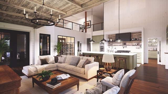 living room featuring wooden ceiling, beam ceiling, dark wood-type flooring, a chandelier, and a high ceiling