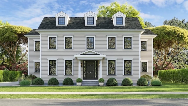 view of front of home featuring roof with shingles and a front yard