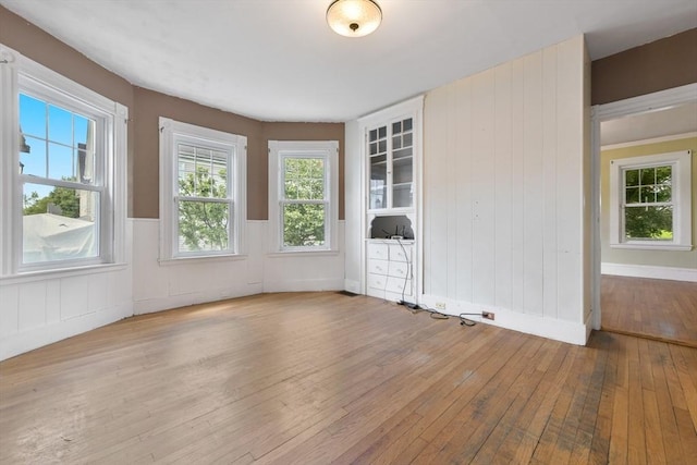 120 Readville St, Boston, MA 02136 - spare room with wood-type flooring, plenty of natural light, and wainscoting