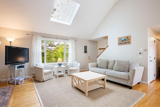 94 Pine View Dr, Brewster, MA 02631 - living room featuring a skylight, light wood-type flooring, and high vaulted ceiling