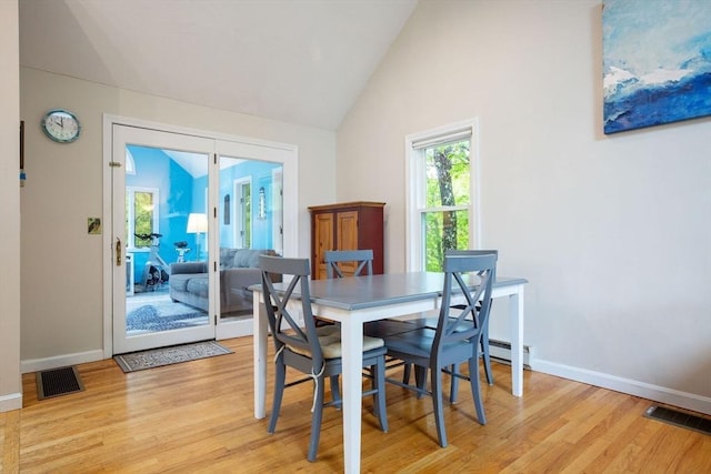 94 Pine View Dr, Brewster, MA 02631 - dining space with a baseboard radiator, light wood-type flooring, and high vaulted ceiling