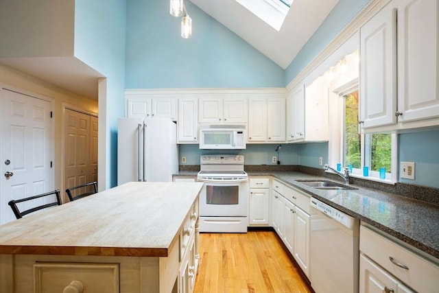 94 Pine View Dr, Brewster, MA 02631 - kitchen featuring white appliances, white cabinets, high vaulted ceiling, and a skylight