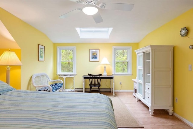 94 Pine View Dr, Brewster, MA 02631 - bedroom with lofted ceiling, baseboard heating, multiple windows, wood finished floors, and a skylight