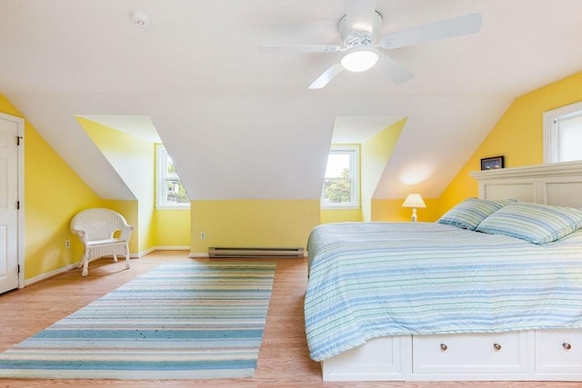 94 Pine View Dr, Brewster, MA 02631 - bedroom featuring a baseboard radiator, multiple windows, lofted ceiling, wood finished floors, and ceiling fan