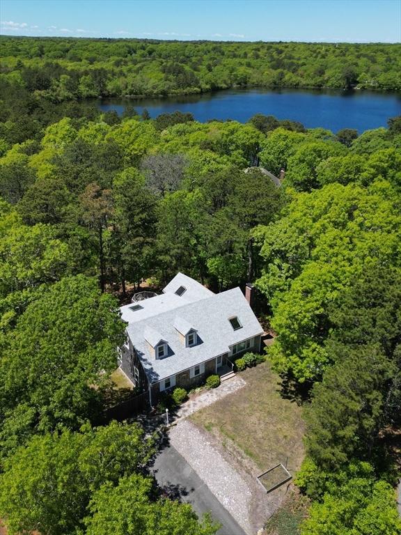 94 Pine View Dr, Brewster, MA 02631 - view from above of property with a heavily wooded area and a nearby body of water