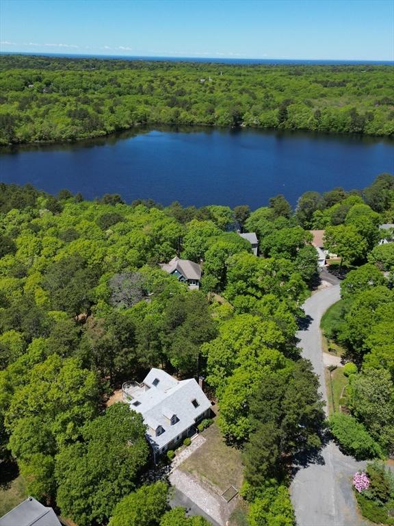 94 Pine View Dr, Brewster, MA 02631 - drone / aerial view of a heavily wooded area and a nearby body of water