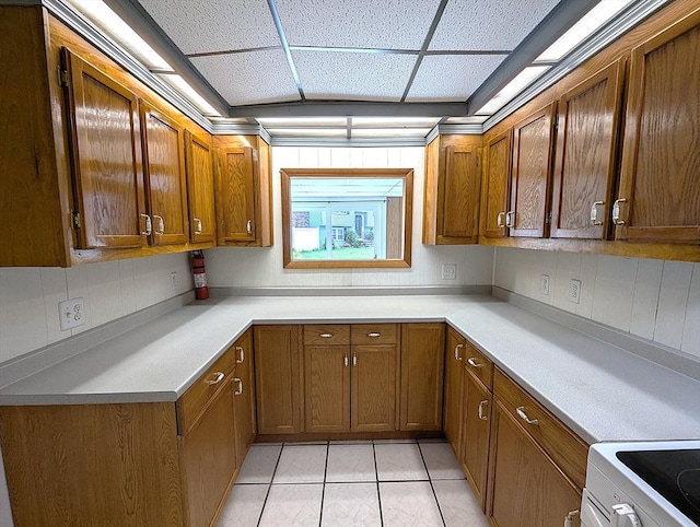 22-24 Newton Ave, Tewksbury, MA 01876 - kitchen featuring white range with electric cooktop, brown cabinetry, a drop ceiling, and light tile patterned flooring