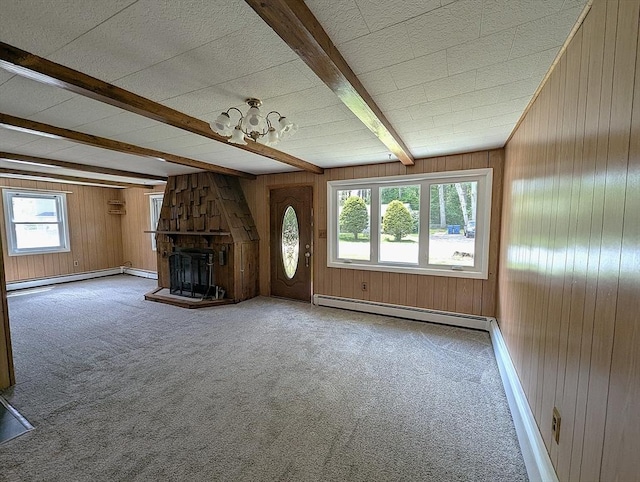 22-24 Newton Ave, Tewksbury, MA 01876 - unfurnished living room with beamed ceiling, wood walls, carpet floors, a baseboard heating unit, and a large fireplace