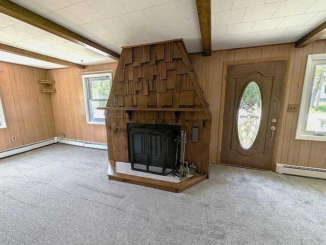 22-24 Newton Ave, Tewksbury, MA 01876 - unfurnished living room with beam ceiling, wooden walls, carpet, a large fireplace, and baseboard heating