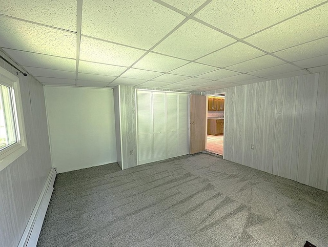 22-24 Newton Ave, Tewksbury, MA 01876 - unfurnished bedroom featuring a paneled ceiling, baseboard heating, carpet, and wooden walls