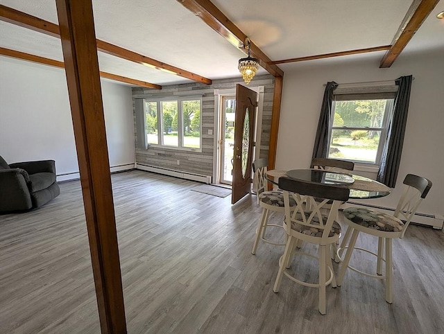 22-24 Newton Ave, Tewksbury, MA 01876 - dining space featuring beam ceiling, wood finished floors, baseboard heating, a baseboard radiator, and baseboards