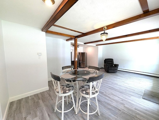 22-24 Newton Ave, Tewksbury, MA 01876 - dining space with a baseboard heating unit, beam ceiling, wood finished floors, and baseboards