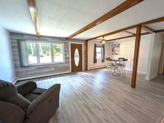 22-24 Newton Ave, Tewksbury, MA 01876 - living room with baseboard heating, light wood-type flooring, baseboards, and beam ceiling