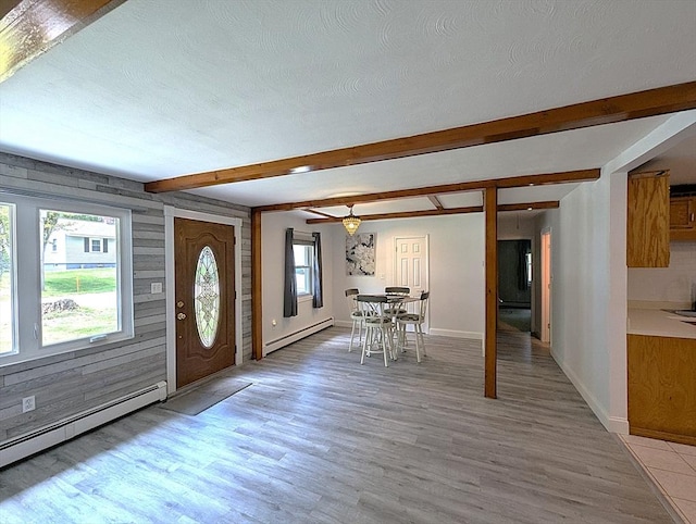 22-24 Newton Ave, Tewksbury, MA 01876 - entrance foyer with a baseboard heating unit, light wood-style flooring, beamed ceiling, and baseboards