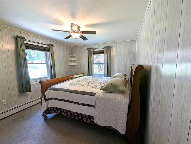 22-24 Newton Ave, Tewksbury, MA 01876 - bedroom with multiple windows, a baseboard heating unit, a ceiling fan, carpet, and wooden walls