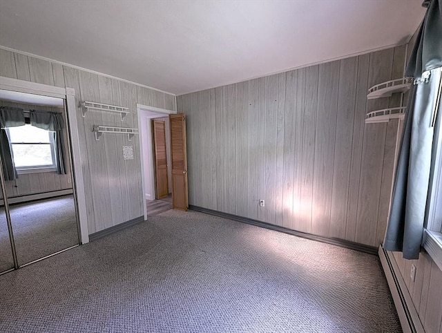 22-24 Newton Ave, Tewksbury, MA 01876 - carpeted empty room featuring a baseboard radiator and wood walls