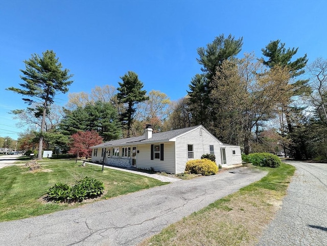 22-24 Newton Ave, Tewksbury, MA 01876 - ranch-style house with a front lawn, a chimney, and asphalt driveway