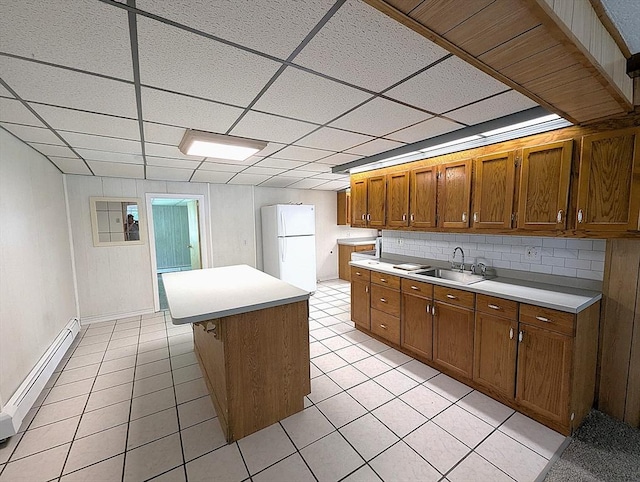 22-24 Newton Ave, Tewksbury, MA 01876 - kitchen featuring freestanding refrigerator, a sink, light countertops, light tile patterned floors, and brown cabinetry