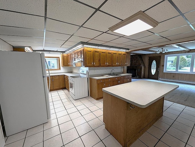 22-24 Newton Ave, Tewksbury, MA 01876 - kitchen featuring white appliances, a baseboard radiator, light tile patterned flooring, light countertops, and brown cabinetry