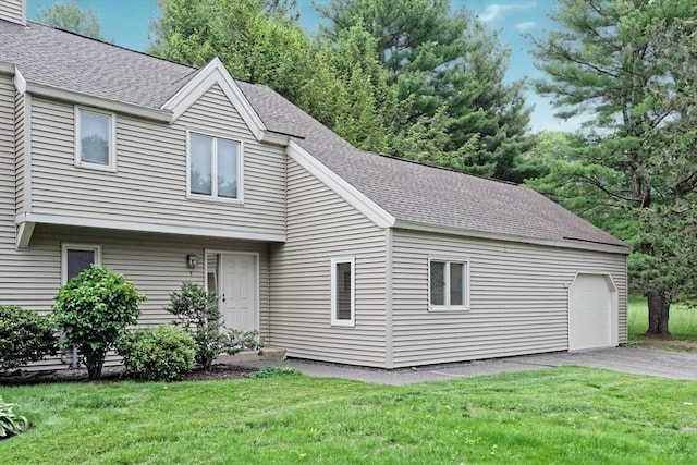 1 Astra Unit 1, Wayland, MA 01778 - view of front of house featuring roof with shingles, a front yard, driveway, and a garage