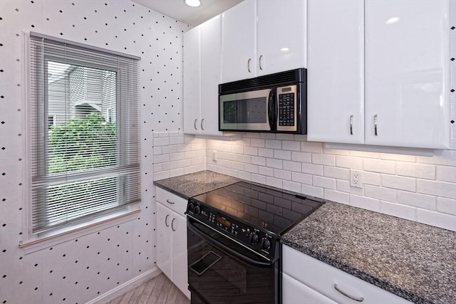 1 Astra Unit 1, Wayland, MA 01778 - kitchen featuring stainless steel microwave, black / electric stove, wallpapered walls, white cabinetry, and baseboards