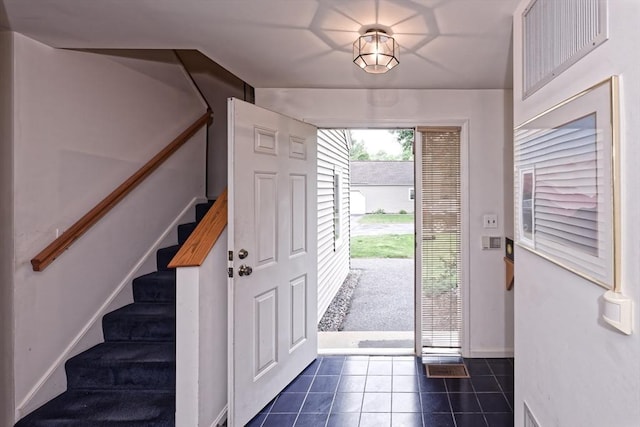1 Astra Unit 1, Wayland, MA 01778 - entrance foyer featuring dark tile patterned floors, stairs, and baseboards