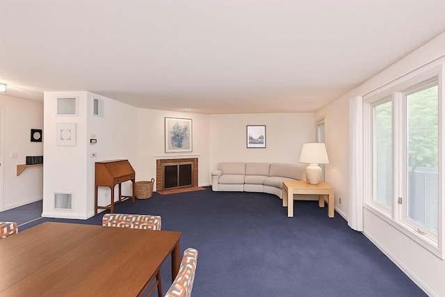 1 Astra Unit 1, Wayland, MA 01778 - living room with a brick fireplace, dark carpet, and baseboards