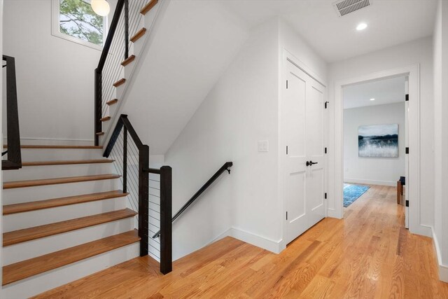 110 Harvard St, Newton, MA 02460 - stairs with wood finished floors, baseboards, visible vents, and recessed lighting