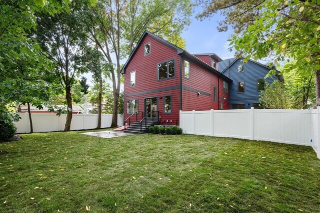 110 Harvard St, Newton, MA 02460 - rear view of property with a fenced backyard and a lawn