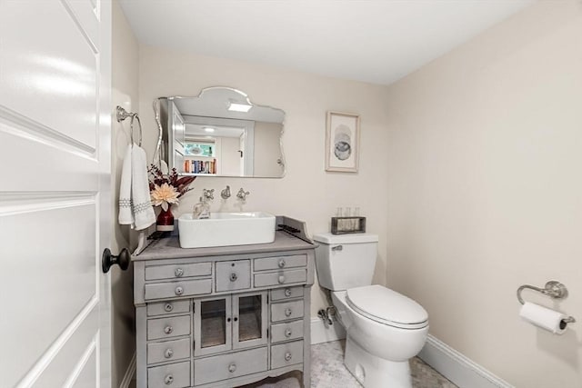 26 Woodward Ave, Reading, MA 01867 - bathroom with toilet, vanity, and baseboards