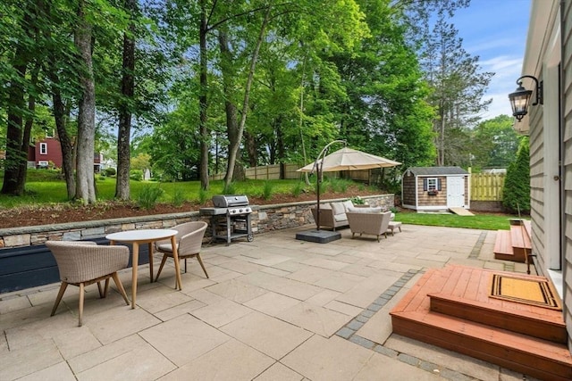 26 Woodward Ave, Reading, MA 01867 - fenced backyard featuring a patio, outdoor dining area, view of scattered trees, and grilling area