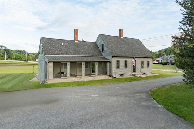 79 Wapping Rd, Kingston, MA 02364 - back of property featuring a yard, roof with shingles, and asphalt driveway