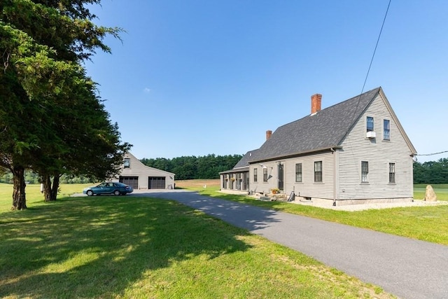79 Wapping Rd, Kingston, MA 02364 - view of front of house featuring a chimney, a garage, a front lawn, and roof with shingles