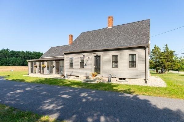 79 Wapping Rd, Kingston, MA 02364 - rear view of house featuring a chimney, a sunroom, and a yard
