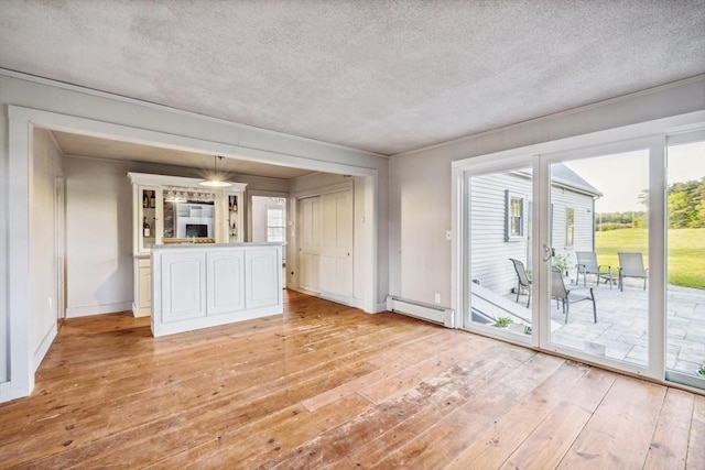 79 Wapping Rd, Kingston, MA 02364 - unfurnished living room featuring baseboard heating, a textured ceiling, light wood-style floors, plenty of natural light, and baseboards