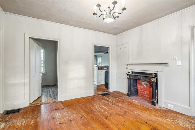 79 Wapping Rd, Kingston, MA 02364 - unfurnished living room featuring a chandelier, light wood-type flooring, and a fireplace with flush hearth